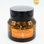 A jar of MOLIAE Beauty Hiya Aloe Gold Queenship face gel with gold flakes visible inside, featuring a black lid and an orange label, set against a plain white background with a gold 'NEW' badge in the top right corner.